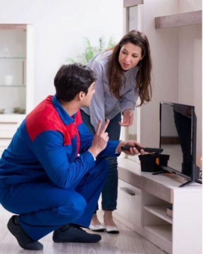 Technician Repairing TV